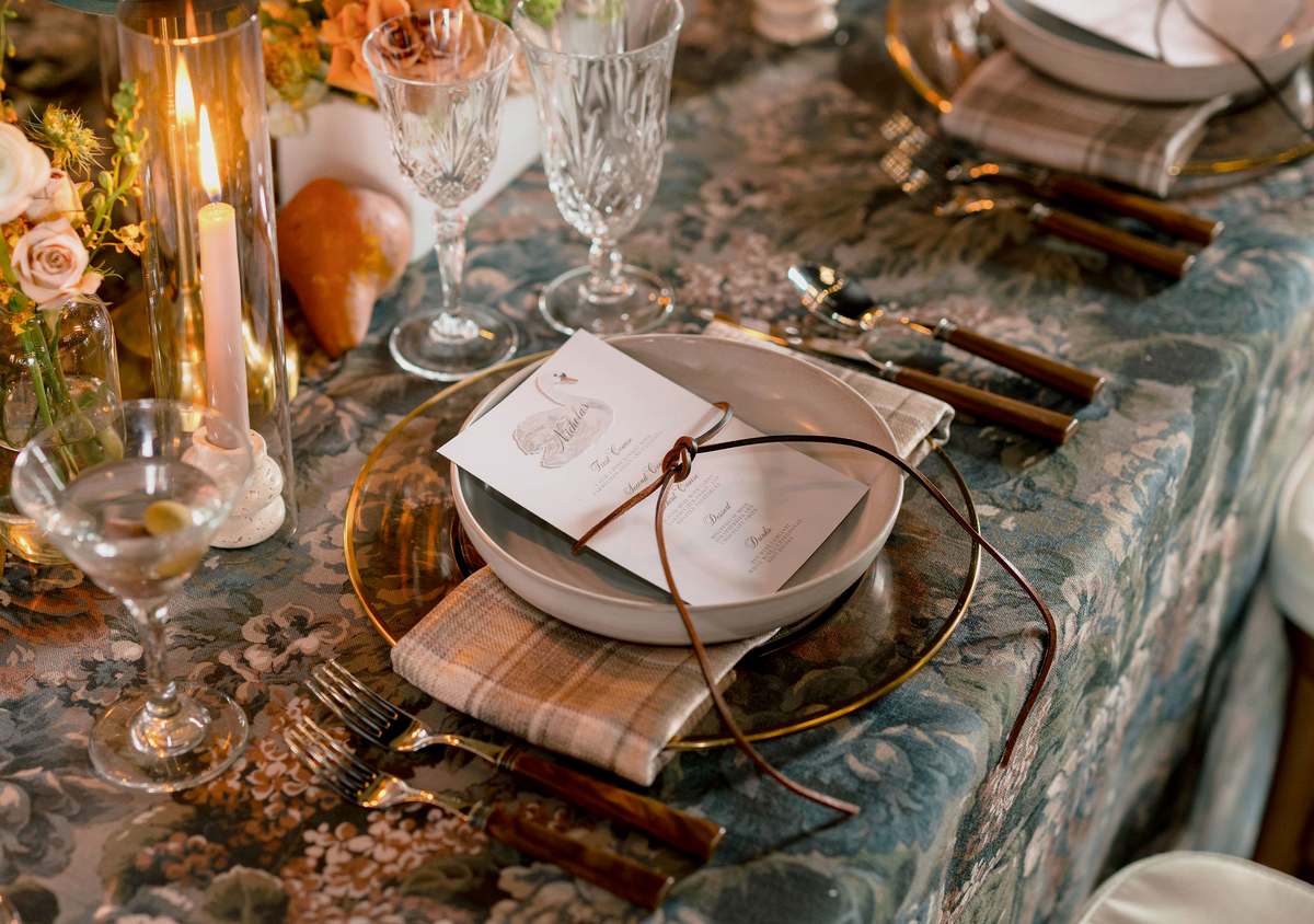 mocha glass charger with gold rim for rent; wood handled flatware for rent; crystal water and wine glasses for rent